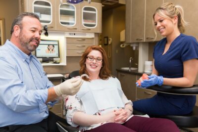 Dr. Clark discusses Invisalign clear aligners with a patient.