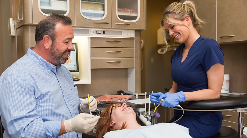 Here Dr. Clark works with one of his dental assistants during a routine checkup.